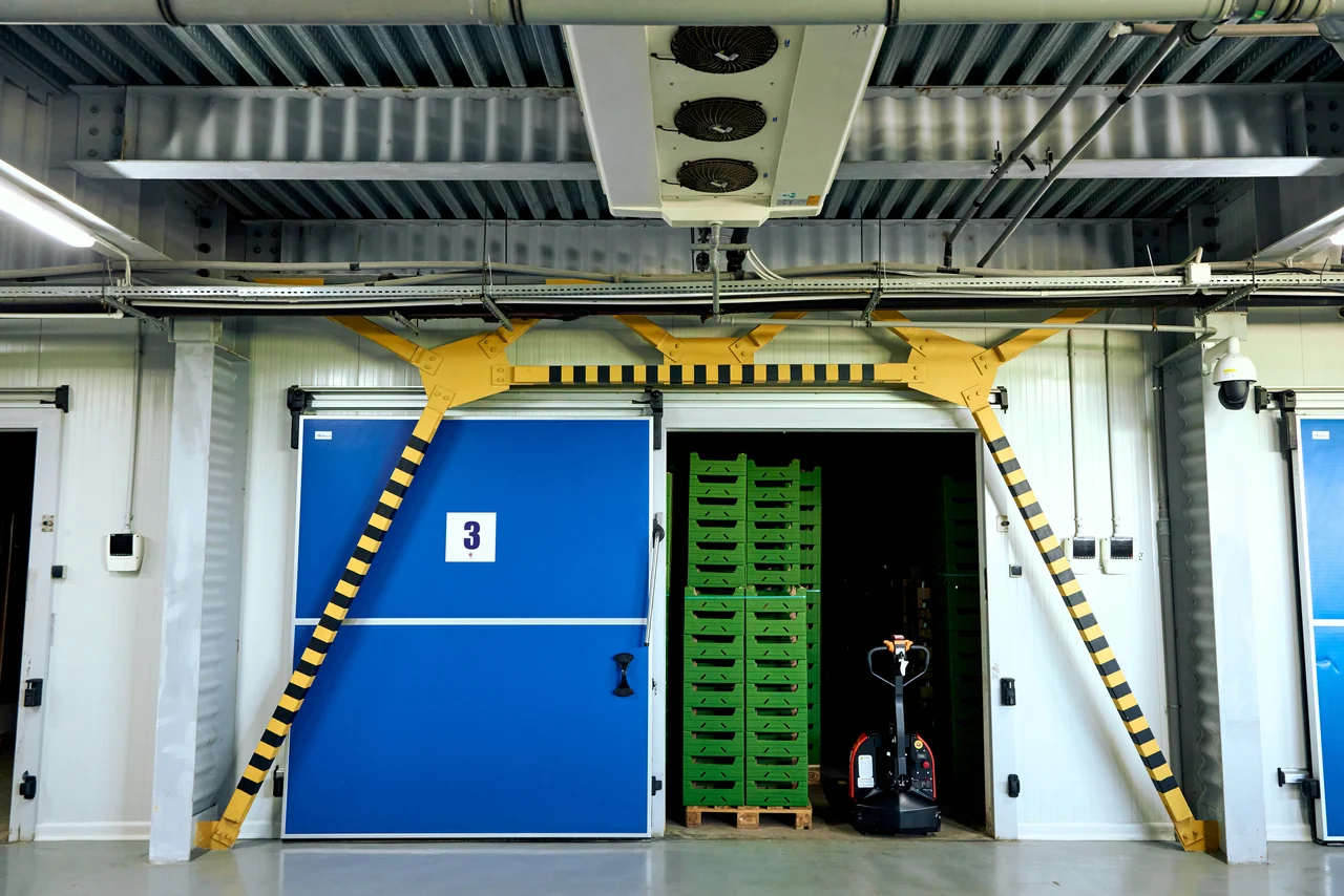 Cold storage room door with stacked crates inside